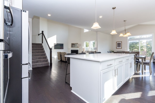 kitchen featuring dark wood finished floors, a wealth of natural light, white cabinets, and freestanding refrigerator