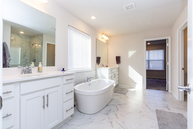 full bathroom featuring a marble finish shower, visible vents, a soaking tub, marble finish floor, and a sink