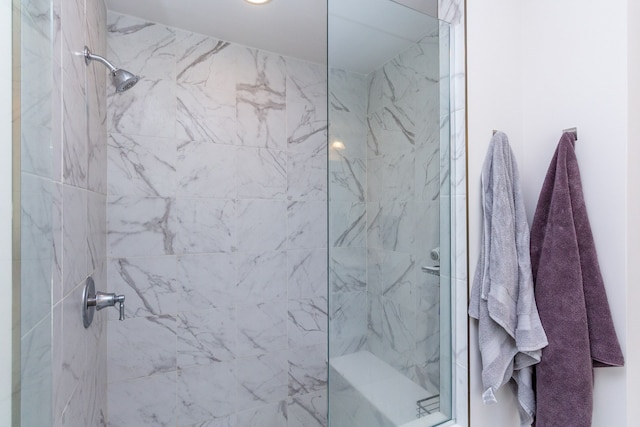 bathroom with a marble finish shower