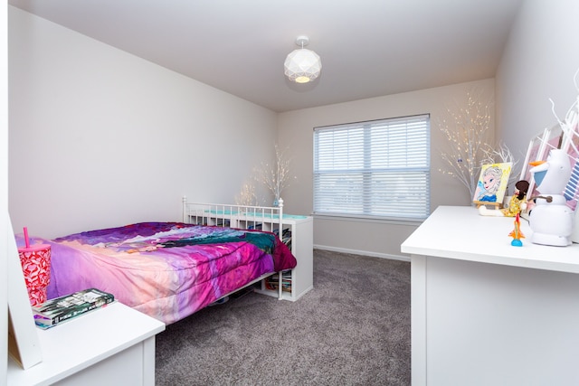 bedroom with baseboards and carpet