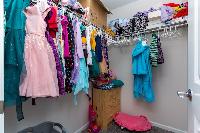 walk in closet with carpet flooring