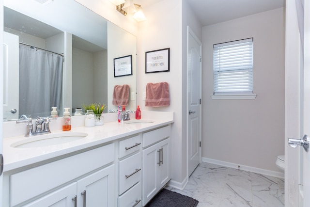 full bathroom featuring a sink, baseboards, toilet, and marble finish floor