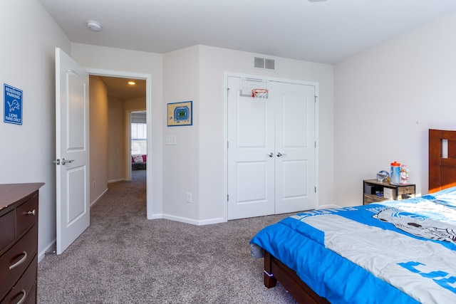 carpeted bedroom featuring a closet, visible vents, and baseboards