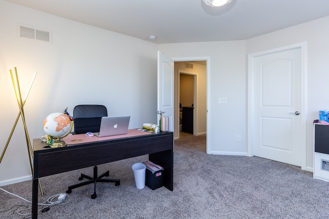 office area featuring baseboards, visible vents, and carpet floors