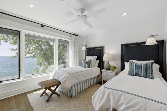 bedroom with a ceiling fan, recessed lighting, wood finished floors, and visible vents