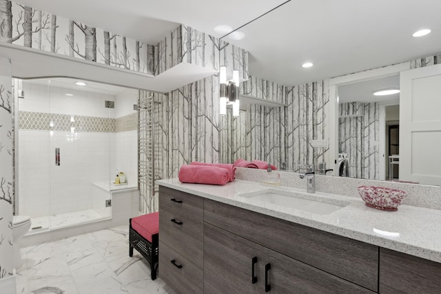 bathroom with recessed lighting, marble finish floor, a stall shower, and vanity