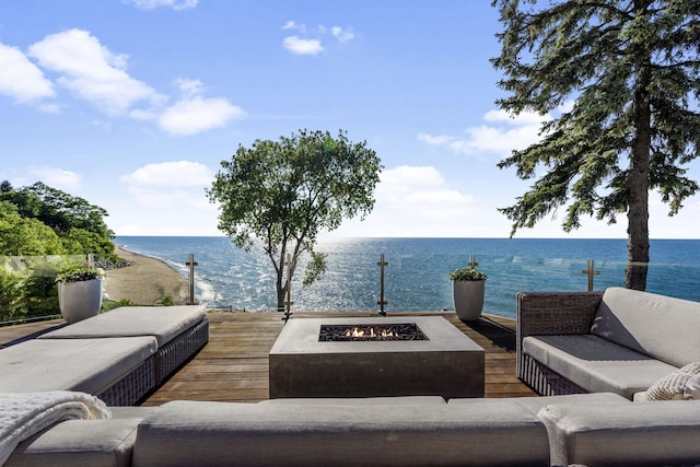 view of patio / terrace with an outdoor living space with a fire pit and a water view