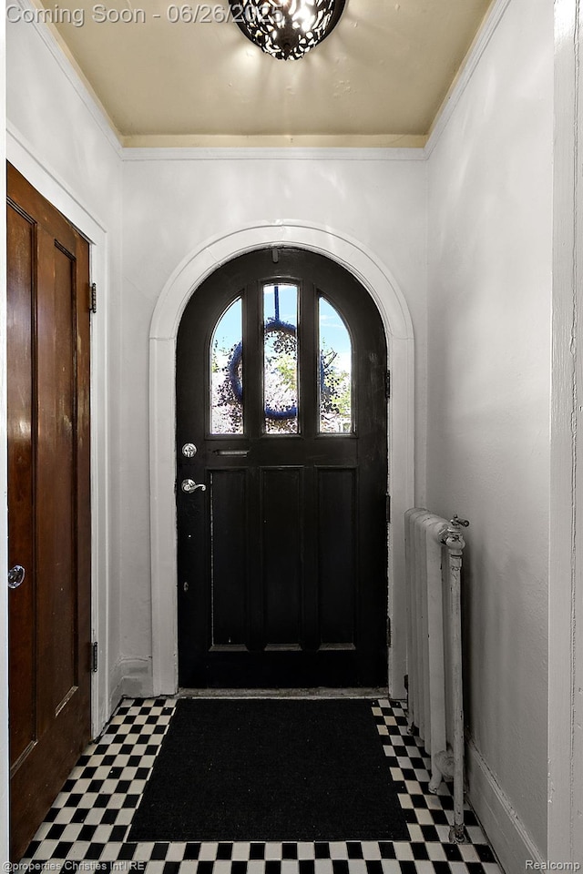 19344 Strathcona Dr, Detroit, MI 48203 - foyer featuring arched walkways, tile patterned floors, and radiator heating unit