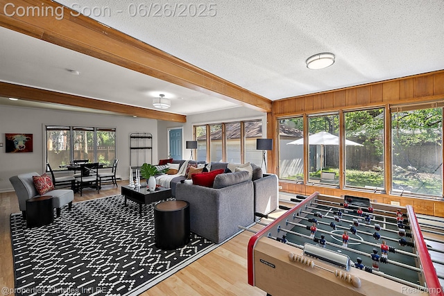 19344 Strathcona Dr, Detroit, MI 48203 - living room with wood finished floors, plenty of natural light, beamed ceiling, and a textured ceiling