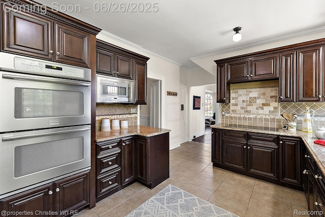 19344 Strathcona Dr, Detroit, MI 48203 - kitchen featuring stainless steel double oven, white microwave, tasteful backsplash, black electric stovetop, and crown molding