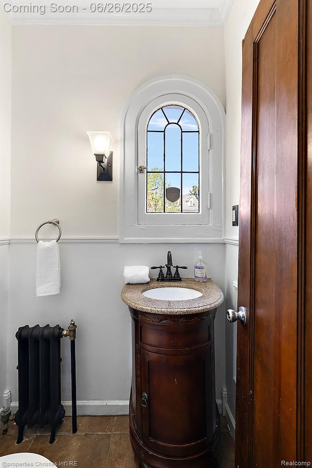 19344 Strathcona Dr, Detroit, MI 48203 - bathroom featuring radiator, vanity, and ornamental molding
