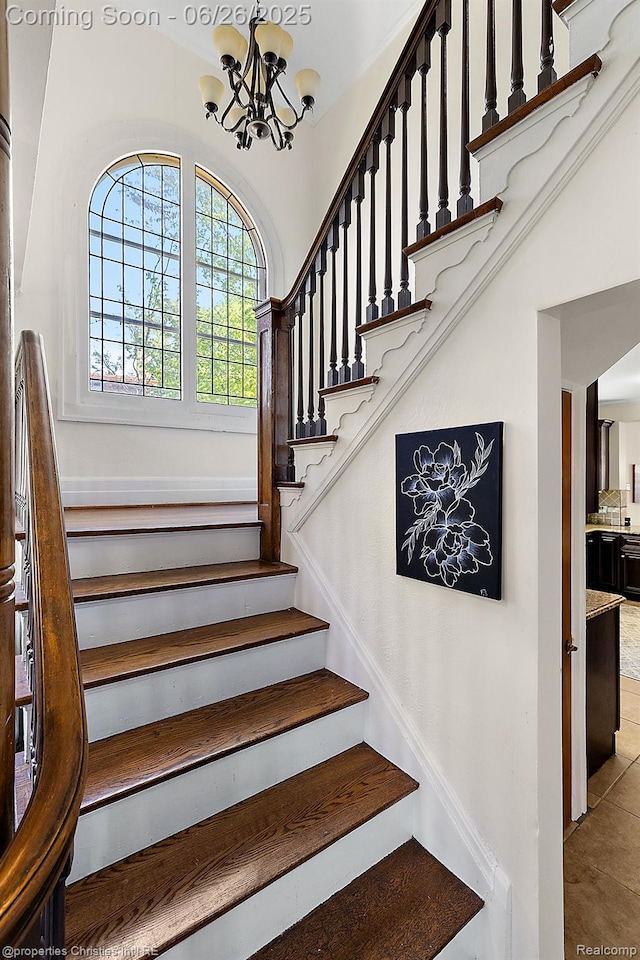 19344 Strathcona Dr, Detroit, MI 48203 - staircase with a chandelier and tile patterned flooring