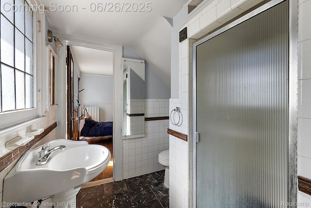 19344 Strathcona Dr, Detroit, MI 48203 - ensuite bathroom featuring radiator heating unit, tile walls, marble look tiles, and a shower stall