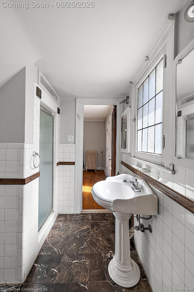 19344 Strathcona Dr, Detroit, MI 48203 - bathroom with radiator heating unit, tile walls, marble finish floors, and wainscoting
