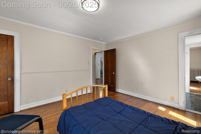 19344 Strathcona Dr, Detroit, MI 48203 - bedroom featuring radiator heating unit, crown molding, and wood finished floors