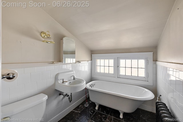 19344 Strathcona Dr, Detroit, MI 48203 - full bath with tile walls, a freestanding bath, lofted ceiling, marble finish flooring, and wainscoting
