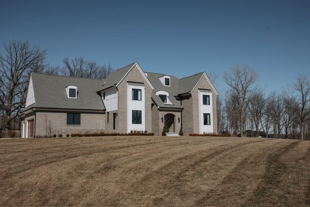 72460 Henry D Dr, Romeo, MI 48065 - view of front of house with a front lawn and a garage