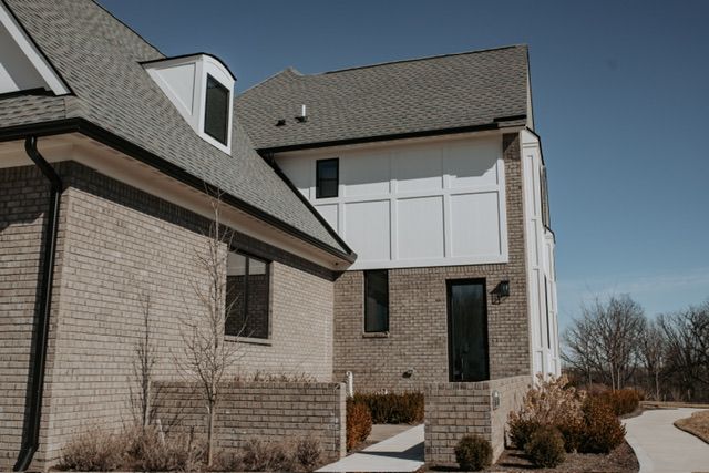 72460 Henry D Dr, Romeo, MI 48065 - view of side of home with brick siding and roof with shingles