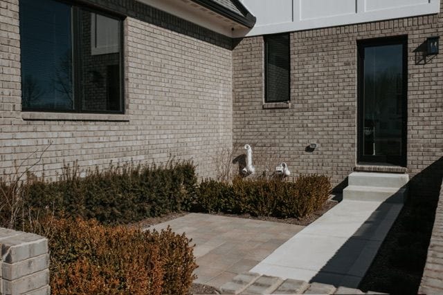 72460 Henry D Dr, Romeo, MI 48065 - exterior space featuring brick siding and a patio area