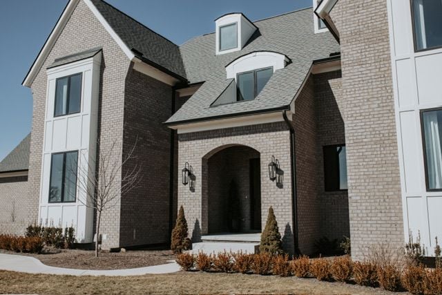 72460 Henry D Dr, Romeo, MI 48065 - doorway to property with brick siding and roof with shingles