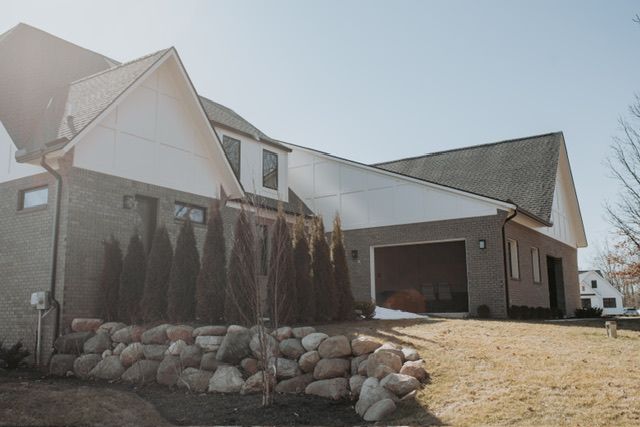72460 Henry D Dr, Romeo, MI 48065 - view of front of home featuring brick siding, an attached garage, and a shingled roof