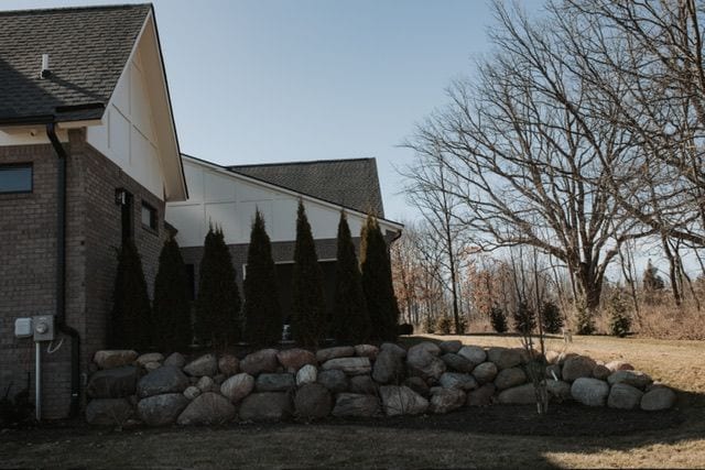 72460 Henry D Dr, Romeo, MI 48065 - view of side of property with brick siding and roof with shingles