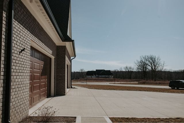 72460 Henry D Dr, Romeo, MI 48065 - view of patio featuring concrete driveway and a garage