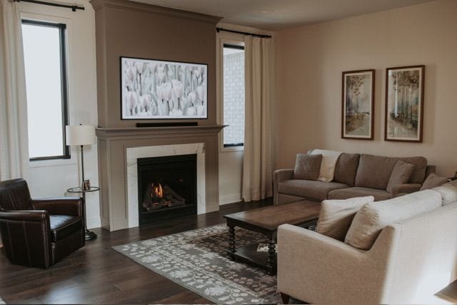 72460 Henry D Dr, Romeo, MI 48065 - living area featuring a warm lit fireplace and dark wood-type flooring