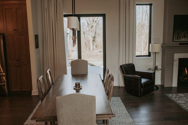 72460 Henry D Dr, Romeo, MI 48065 - dining area with dark wood-type flooring, a healthy amount of sunlight, and a lit fireplace