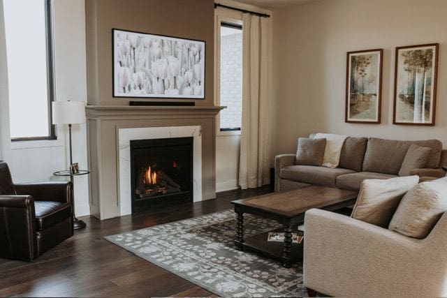 72460 Henry D Dr, Romeo, MI 48065 - living area featuring a lit fireplace and wood finished floors