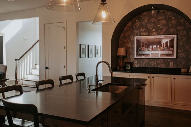 72460 Henry D Dr, Romeo, MI 48065 - kitchen with dark countertops, an island with sink, dark wood-style floors, and a sink