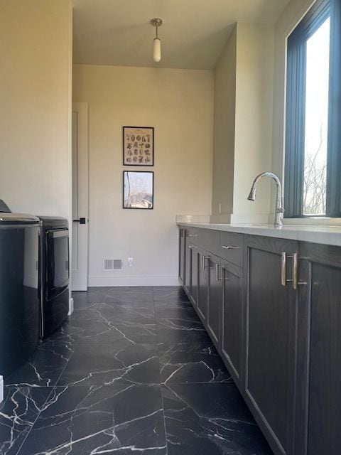 72460 Henry D Dr, Romeo, MI 48065 - interior space with visible vents, baseboards, marble finish floor, and washer and clothes dryer