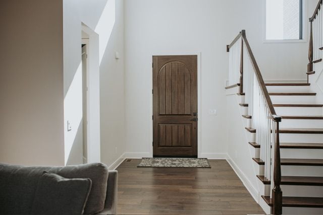 72460 Henry D Dr, Romeo, MI 48065 - entryway with dark wood finished floors, stairs, and baseboards
