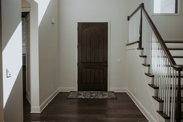 72460 Henry D Dr, Romeo, MI 48065 - foyer entrance with stairs, wood finished floors, and baseboards