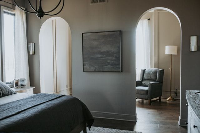 72460 Henry D Dr, Romeo, MI 48065 - bedroom featuring multiple windows, arched walkways, and dark wood-style flooring