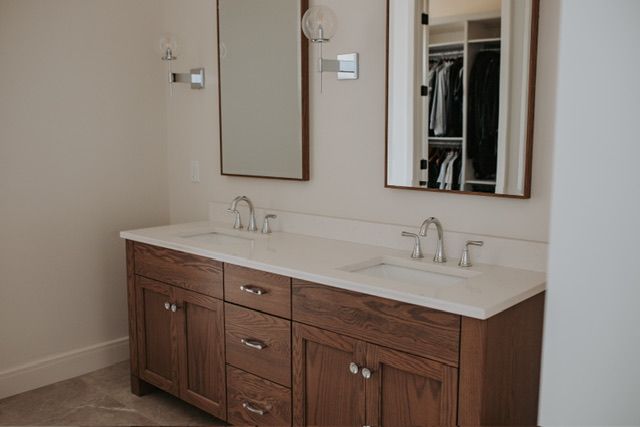 72460 Henry D Dr, Romeo, MI 48065 - full bathroom featuring a sink, a walk in closet, baseboards, and double vanity