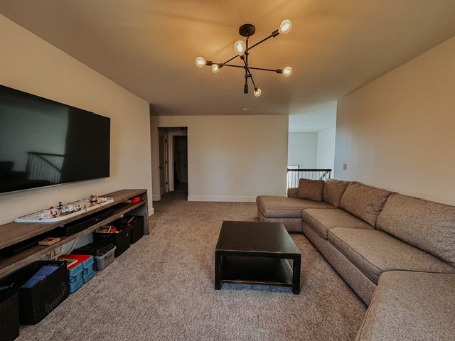 72460 Henry D Dr, Romeo, MI 48065 - living room with carpet flooring and a notable chandelier
