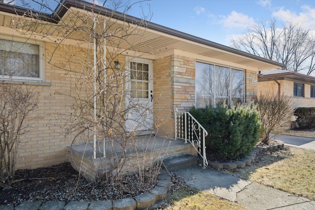 entrance to property with stone siding and brick siding