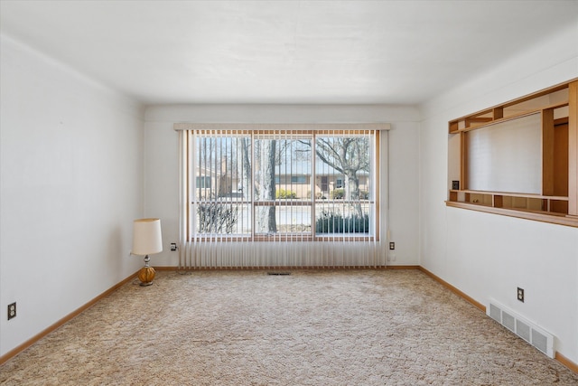 unfurnished room featuring baseboards, visible vents, and carpet floors