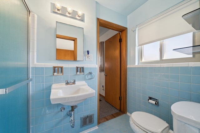 bathroom with a wainscoted wall, tile walls, toilet, and visible vents