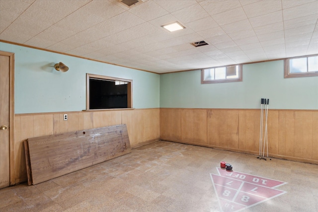 unfurnished room with a wealth of natural light and wainscoting