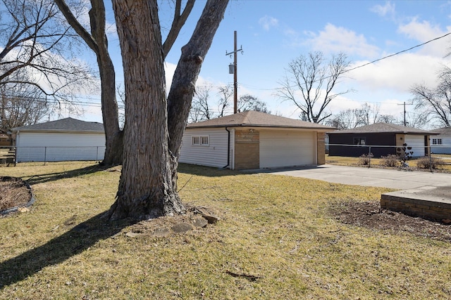 exterior space with a garage, an outdoor structure, driveway, and fence