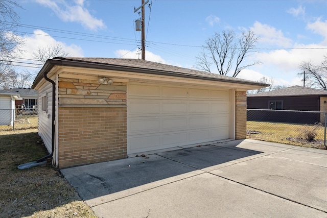 detached garage featuring fence