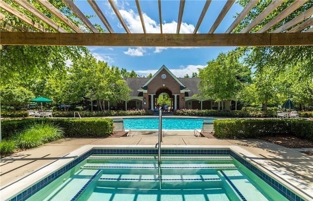 community pool with a patio area and a pergola