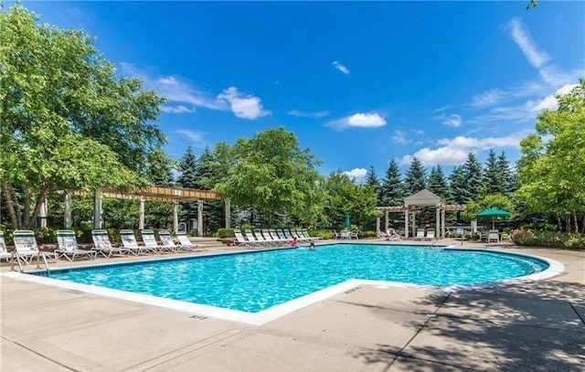 pool with a patio and a pergola