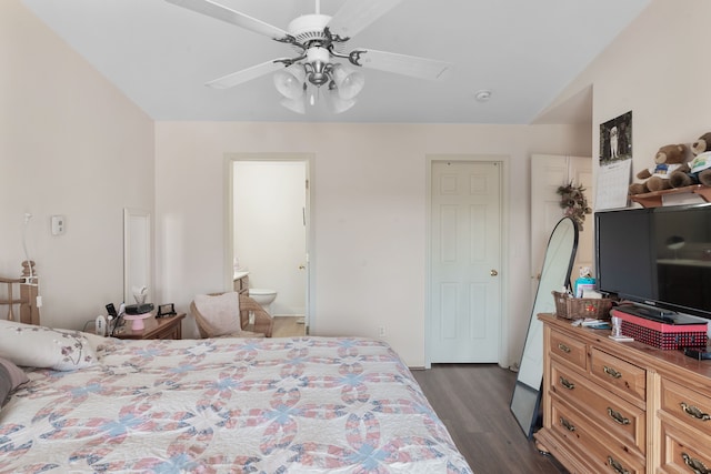 bedroom featuring a ceiling fan, dark wood-style floors, and connected bathroom