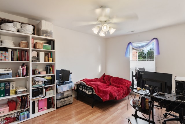 bedroom with light wood-type flooring, visible vents, and a ceiling fan