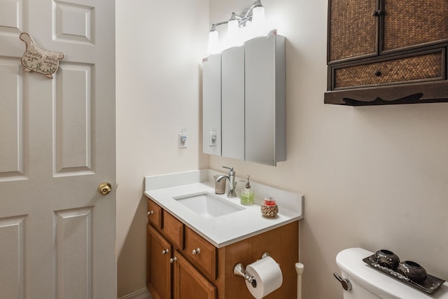 bathroom featuring toilet and vanity