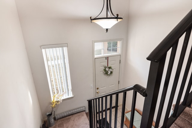 entrance foyer with stairs and carpet floors