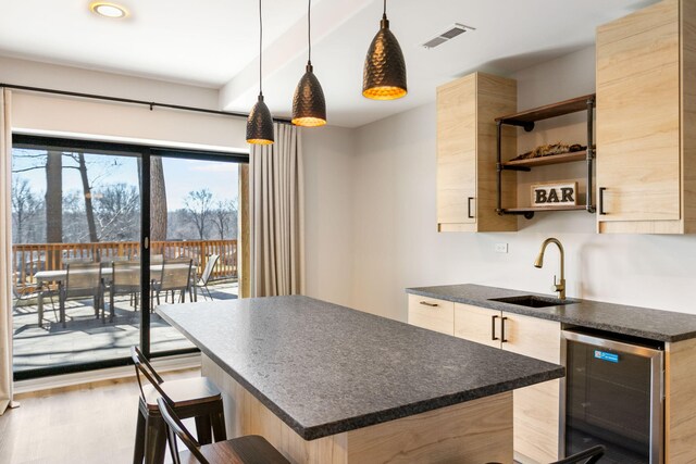 2060 S Algonquin Dr, Benton Harbor, MI 49022 - kitchen featuring beverage cooler, modern cabinets, a kitchen breakfast bar, wood finished floors, and recessed lighting